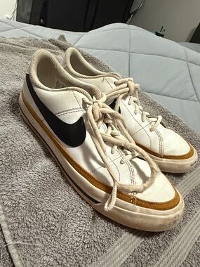 Nike White Low-Top Sneakers with Mustard Stripe and Black Swoosh